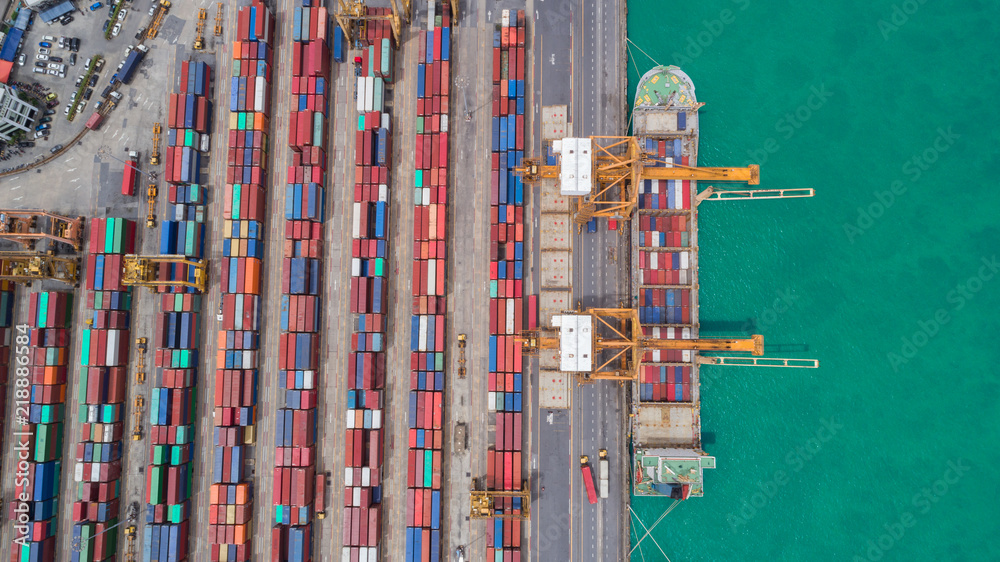 Obraz premium Aerial view ship container at commercial port for international import export or transportation concept background.