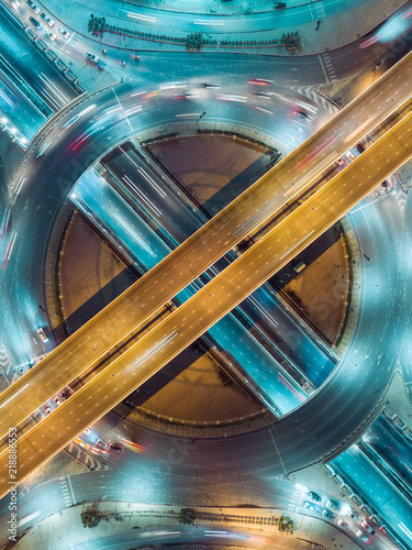 Aerial view highway road intersection at night for transportation, distribution or traffic background.