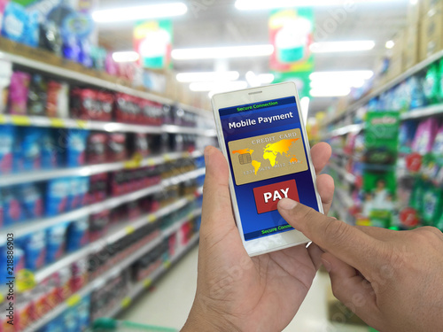 mobile payment, Male hands using smartphone confirms payment by credit card for online payment in supermarket, A digital wallet to pay for goods and services to convenient and fast. Business concept.