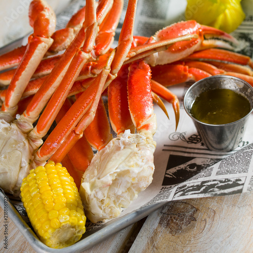 Crab legs and yellow corn n a silver tray
