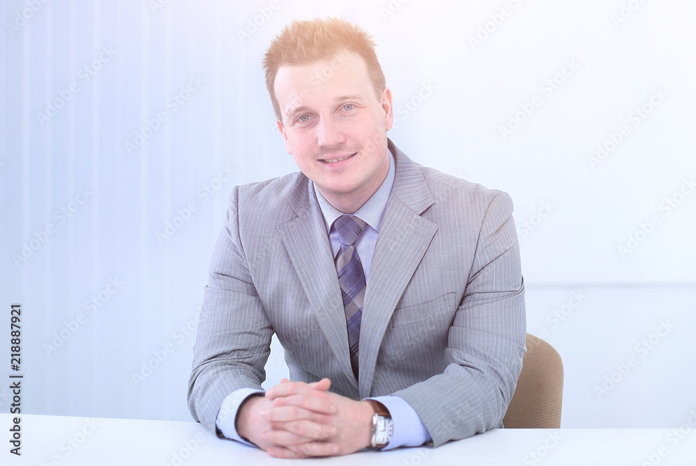 successful businessman sitting behind a Desk successful businessman sitting behind a Desk