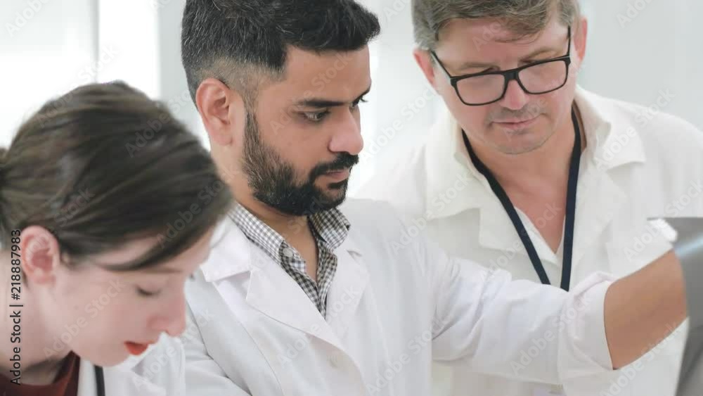 Team of doctors at trauma Department while working. Podiatrists diagnose a difficult disease of the patient. Group of orthopedists at work Team of doctors at trauma Department while working. Podiatrists diagnose a difficult disease of the patient. Group of orthopedists at work