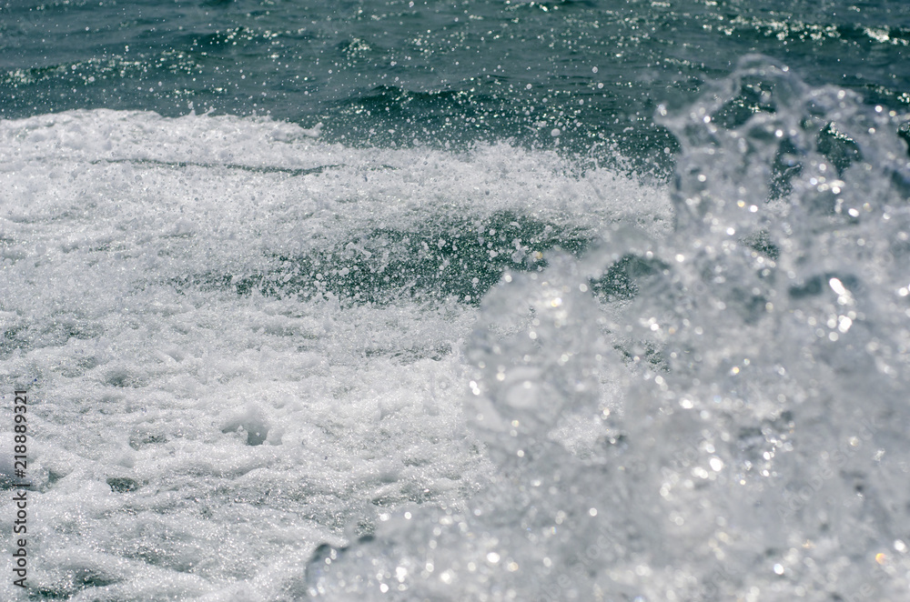 Spray and foam against a wavy sea surface. Spray and foam against a wavy sea surface.