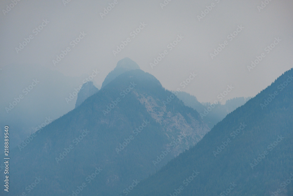 layered mountains with peaks under the heavy smoke in the morning layered mountains with peaks under the heavy smoke in the morning