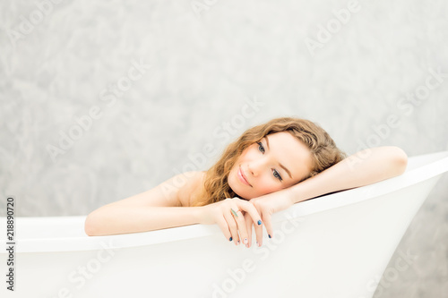 Young woman relaxing in bath.beautiful woman lying in bathtub.