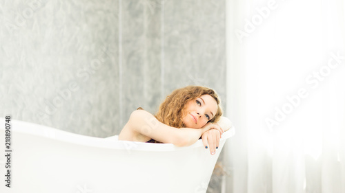 Young woman relaxing in bath.beautiful woman lying in bathtub.