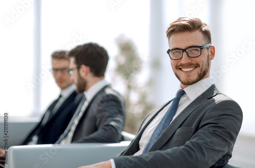 close up.happy businessman sitting in modern office