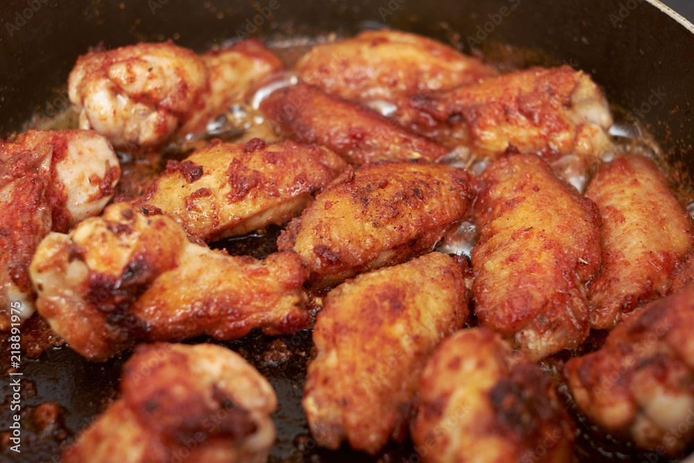 Chicken wings fried in pan with hot oil, homemade food