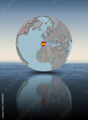 Spain on globe above water surface