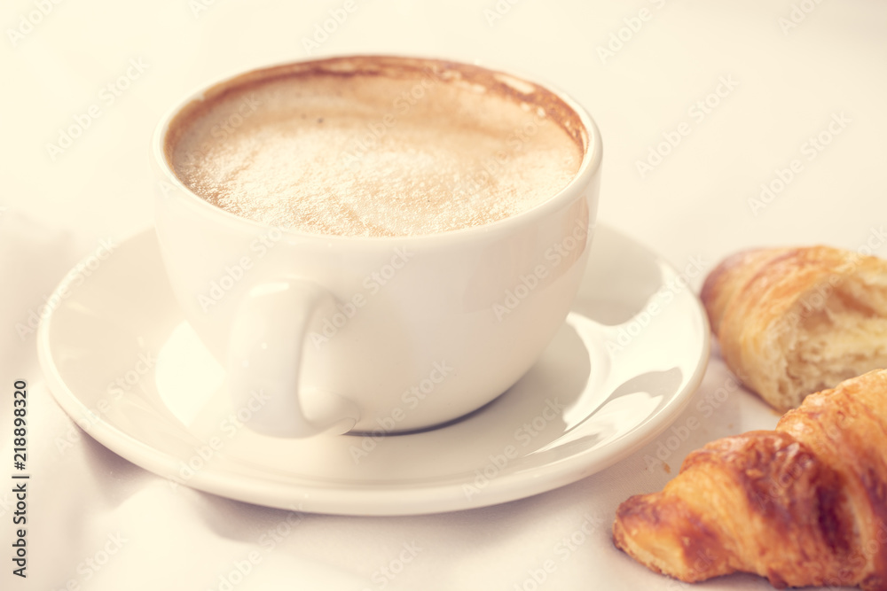 Coffee and croissant for breakfast with shallow depth of field. Coffee and croissant for breakfast with shallow depth of field.