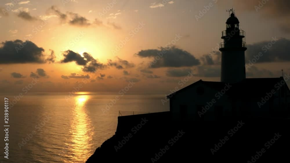 Lighthouse on Rocky Cliff with Spectacular Clouds on Mallorca at Sunrise Lighthouse on Rocky Cliff with Spectacular Clouds on Mallorca at Sunrise