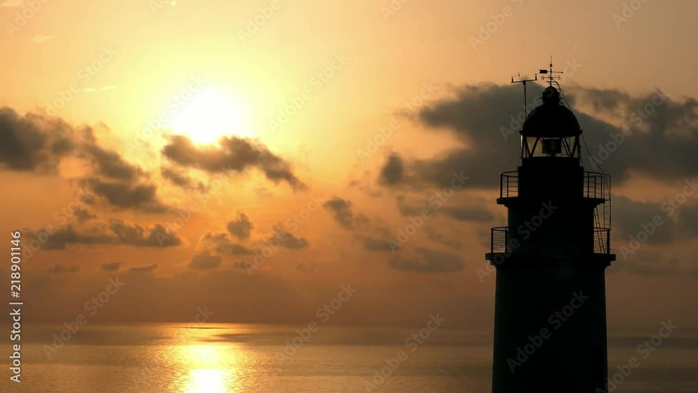 Lighthouse on Rocky Cliff with Spectacular Clouds on Mallorca at Sunrise Lighthouse on Rocky Cliff with Spectacular Clouds on Mallorca at Sunrise