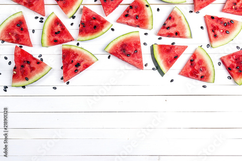 Sliced watermelon on white wooden background with copy space.