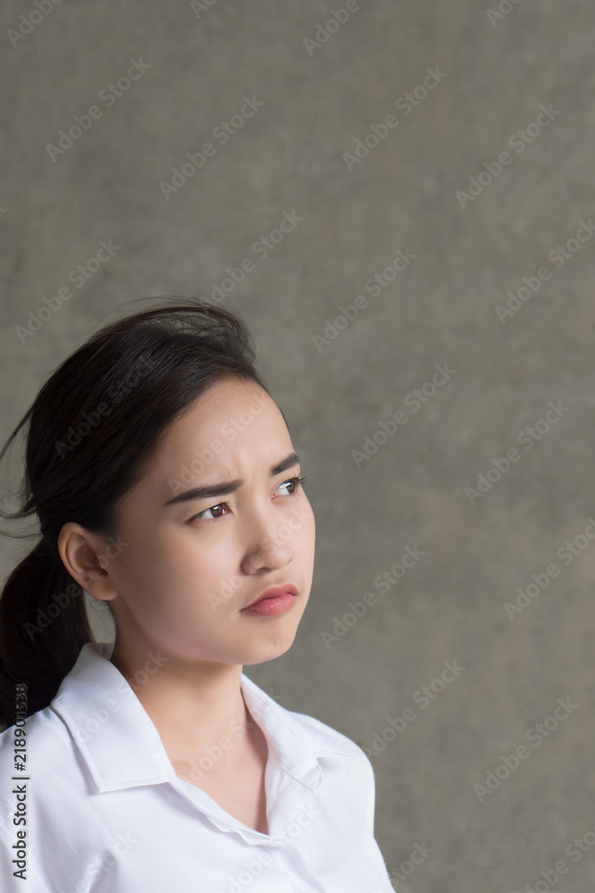 serious upset woman thinking, planning; portrait of thoughtful, serious, pensive, frustrated asian woman looking up, thinking, finding idea with tension or bad mood; 20s young adult asian woman model serious upset woman thinking, planning; portrait of thoughtful, serious, pensive, frustrated asian woman looking up, thinking, finding idea with tension or bad mood; 20s young adult asian woman model