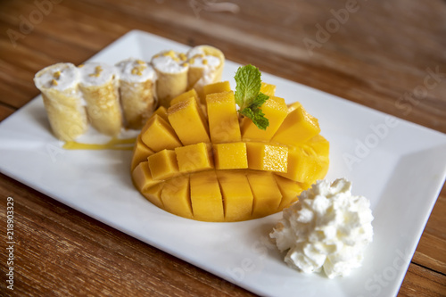 Fototapeta Naklejka Na Ścianę i Meble -  Mango Sticky Rice, and whipped cream, typical Thai sweet, Thai dessert. Mango is Thailand's tropical fruit.