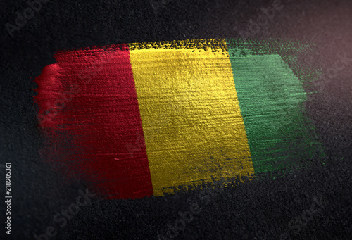 Guinea Flag Made of Metallic Brush Paint on Grunge Dark Wall photo