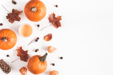 Autumn composition. Pumpkins, candles, dried leaves on white background. Autumn, fall, halloween concept. Flat lay, top view, copy space