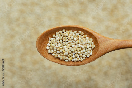 white quinoa seeds on spoon wooden 