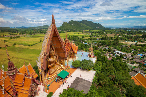 Big golden Buddha statue in Tiger cave temple (Wat thum suea), a buddhist temple of Kanchanaburi Province, Thailand photo