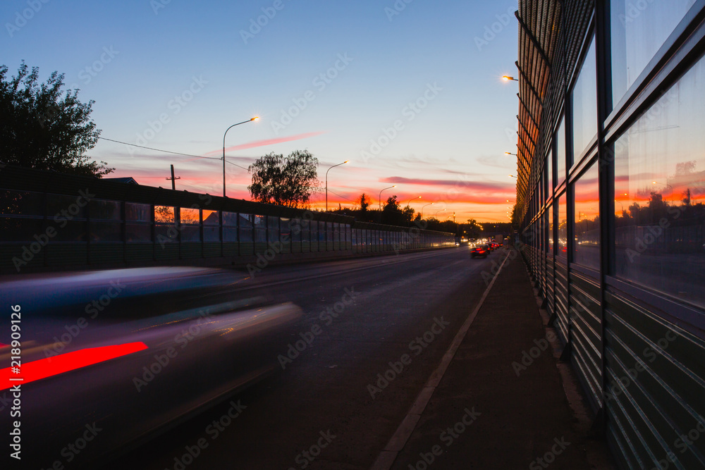 Summer landscape with highway and tracks from car headlights