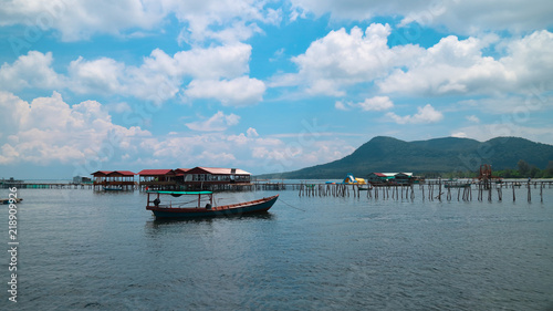 Fisherman boat. Bridge in fishers countryside with beautiful view on turquoise sea, blue sky and mountain view in Phu Quoc, Vietnam