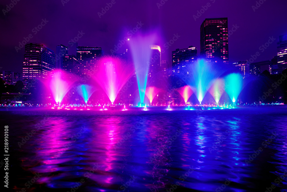 The colorful of fountain on the lake at night, near by Twin Towers; with city on background. Kuala Lumpur, Malaysia.