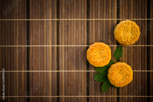 Top down moon cakes on bamboo mat with copy space