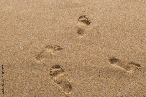 footprints of lovers in the sand on the beach