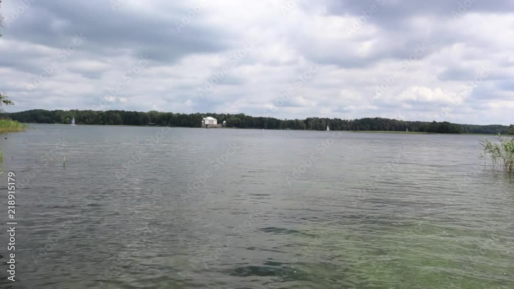 Flying low over the calm river. Beautiful sky, calm water. Trees reflected in the water. Aerial shooting. Flying low over the calm river. Beautiful sky, calm water. Trees reflected in the water. Aerial shooting.