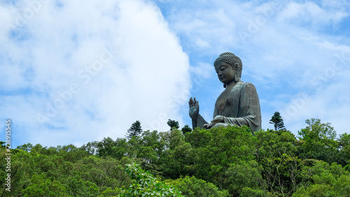 Tian Tan Buddha over the forrest with blue sky background located at Ngong Ping, Lantau Island, in Hong Kong