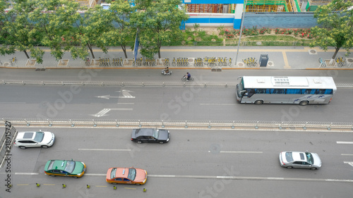 Chinese people ride bike, motorcycle, car, taxi and bus on the street top view, Beijing, China