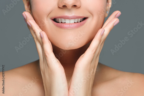 cropped shot of smiling woman with beautiful white teeth isolated on grey