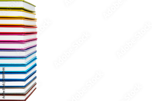Books. A lot of books with bright covers in one pile isolated on white background. Place for text. Design element, paper and leather texture. Colorful books on the shelf, close up