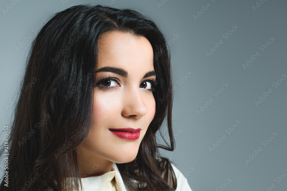 attractive brunette woman with red lips, isolated on grey attractive brunette woman with red lips, isolated on grey