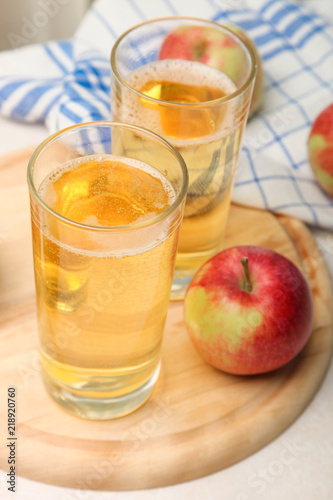 Apple cider in a glass on the window background.