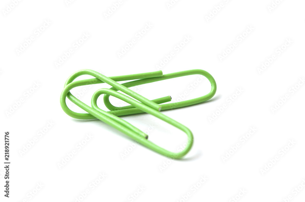 closeup of green paperclips on white background closeup of green paperclips on white background
