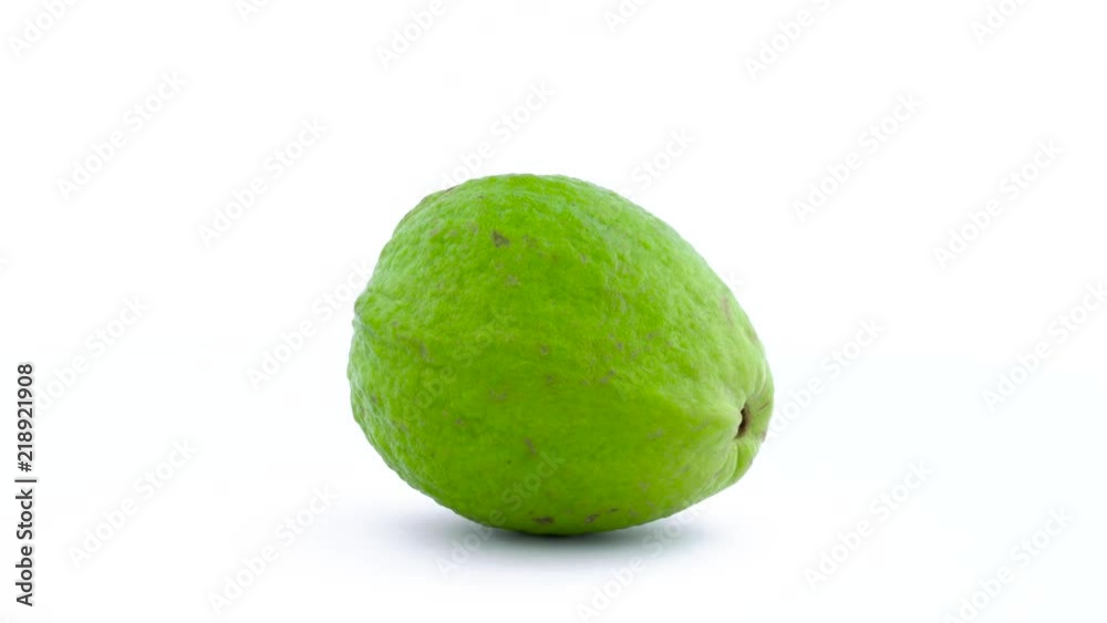 One whole apple guava fruit is rotating on the turntable isolated on the white background. Close up. Macro. One whole apple guava fruit is rotating on the turntable isolated on the white background. Close up. Macro.