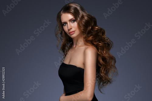 Beautiful hair long curly hairstyle woman with beauty makeup female model portrait