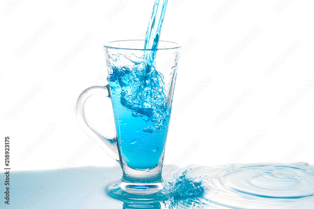 Water splashing into glass of water on white Water splashing into glass of water on white