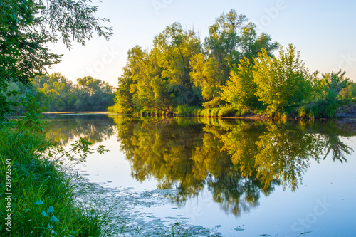 A peaceful river landscape at summer sunset.Late afternoon.