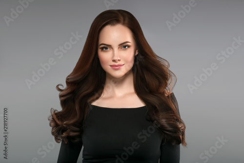 Brunette with perfect hair. Woman beautiful portrait with healthy long hairstyle curly and perfect.