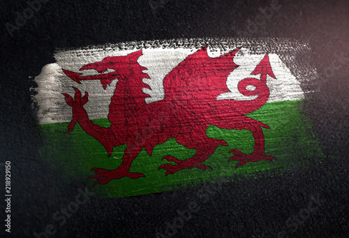 Photos Wales Flag Made of Metallic Brush Paint on Grunge Dark Wall