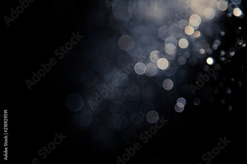 bokeh of water fly and lights on black background,