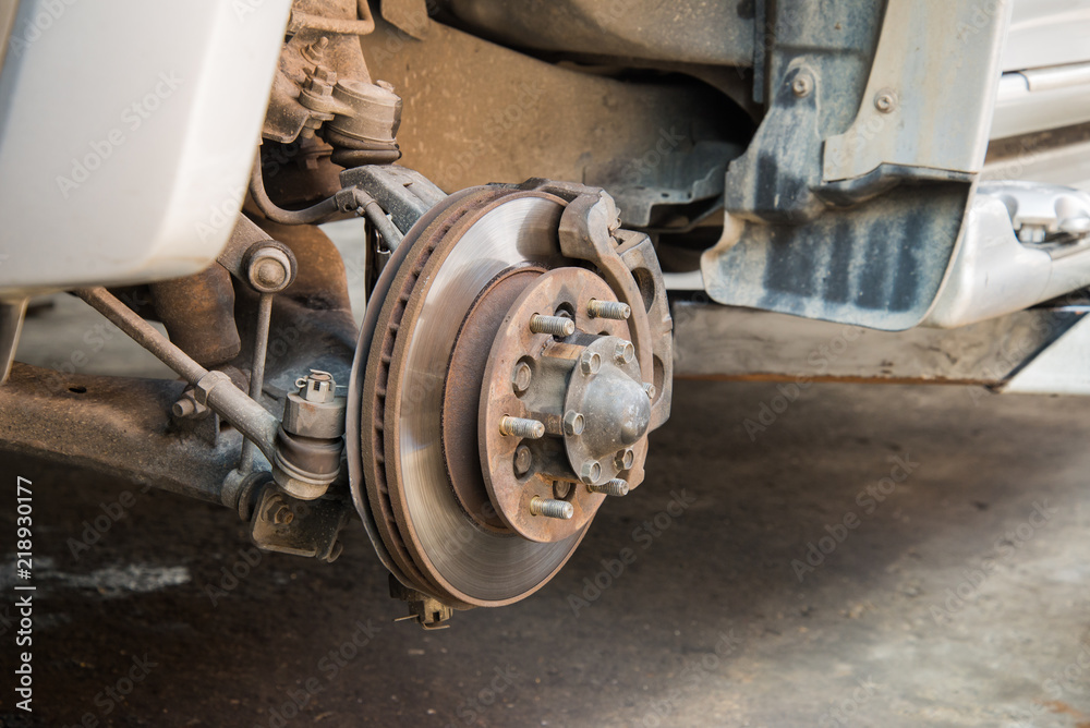Fototapeta premium Repairing disc brake of the mini-truck in the garage