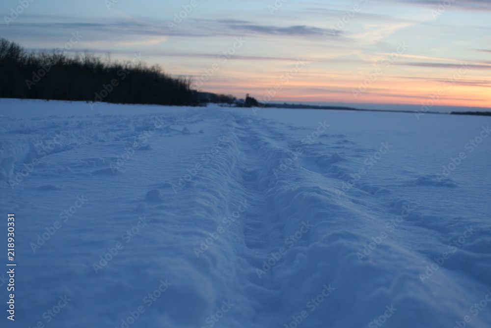 road in the snow at sunset