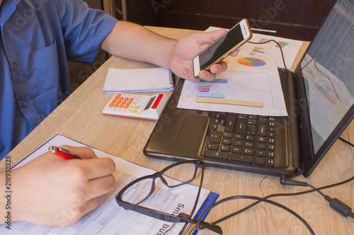 Savings, finances, economy and home concept. man with calculator and making notes at home