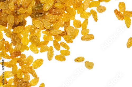 Lot of whole dry golden raisins sultana variety left upper corner flatlay isolated on white background photo