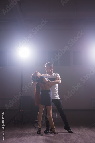 Young couple dancing latin dance Bachata, merengue, salsa. Two elegance pose in dance class