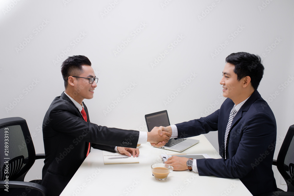Two men handshake in the office Two men handshake in the office