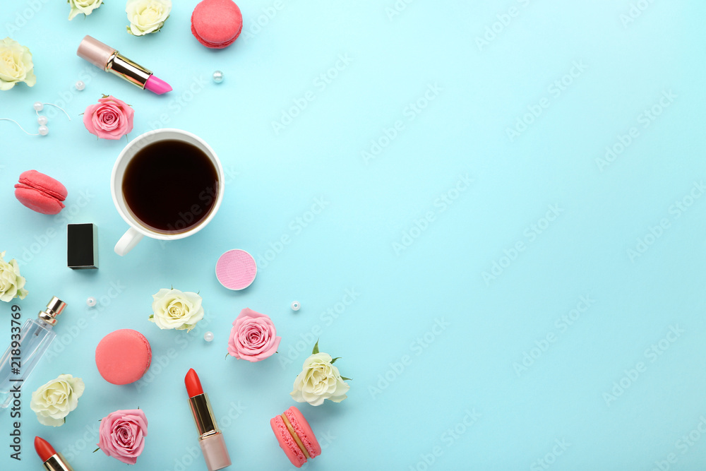 Rose flowers with cup of coffee and makeup cosmetics on blue background